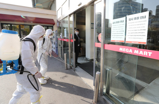 부산에 신종 코로나바이러스 감염증(코로나19) 확진자가 잇따라 발생해 번화가와 관광지가 썰렁한 모습을 보이고 있다. 코로나19 확진자가 방문한 곳으로 알려진 부산 메가마트 동래점에서 방역 활동을 하고 있는 모습. <연합뉴스>